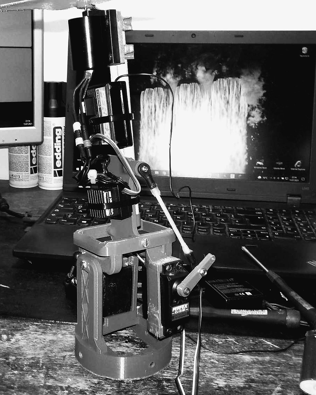 The gimbal clamped to a test stand next to a laptop