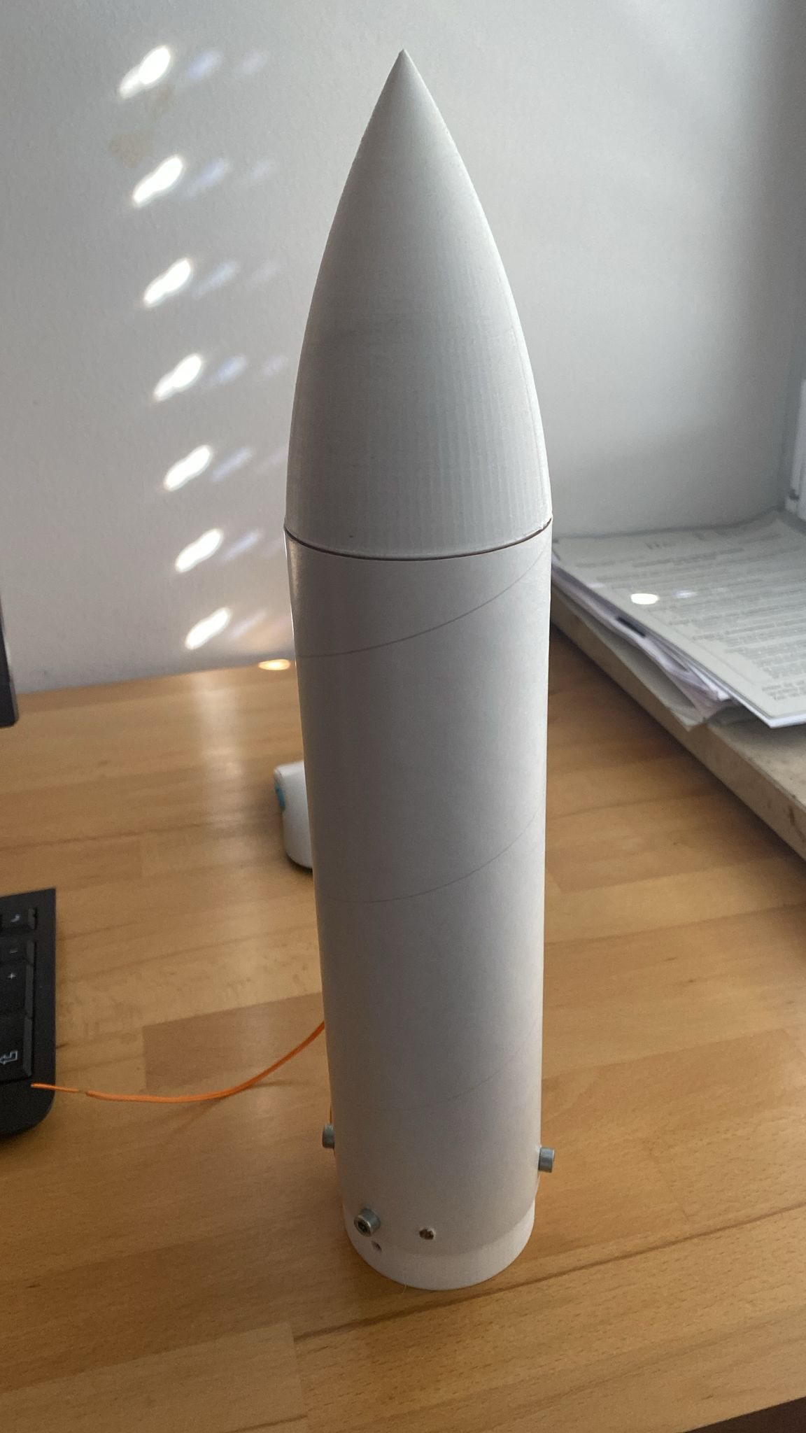 The mk7 nose cone, a white printed ogive, standing on a table
