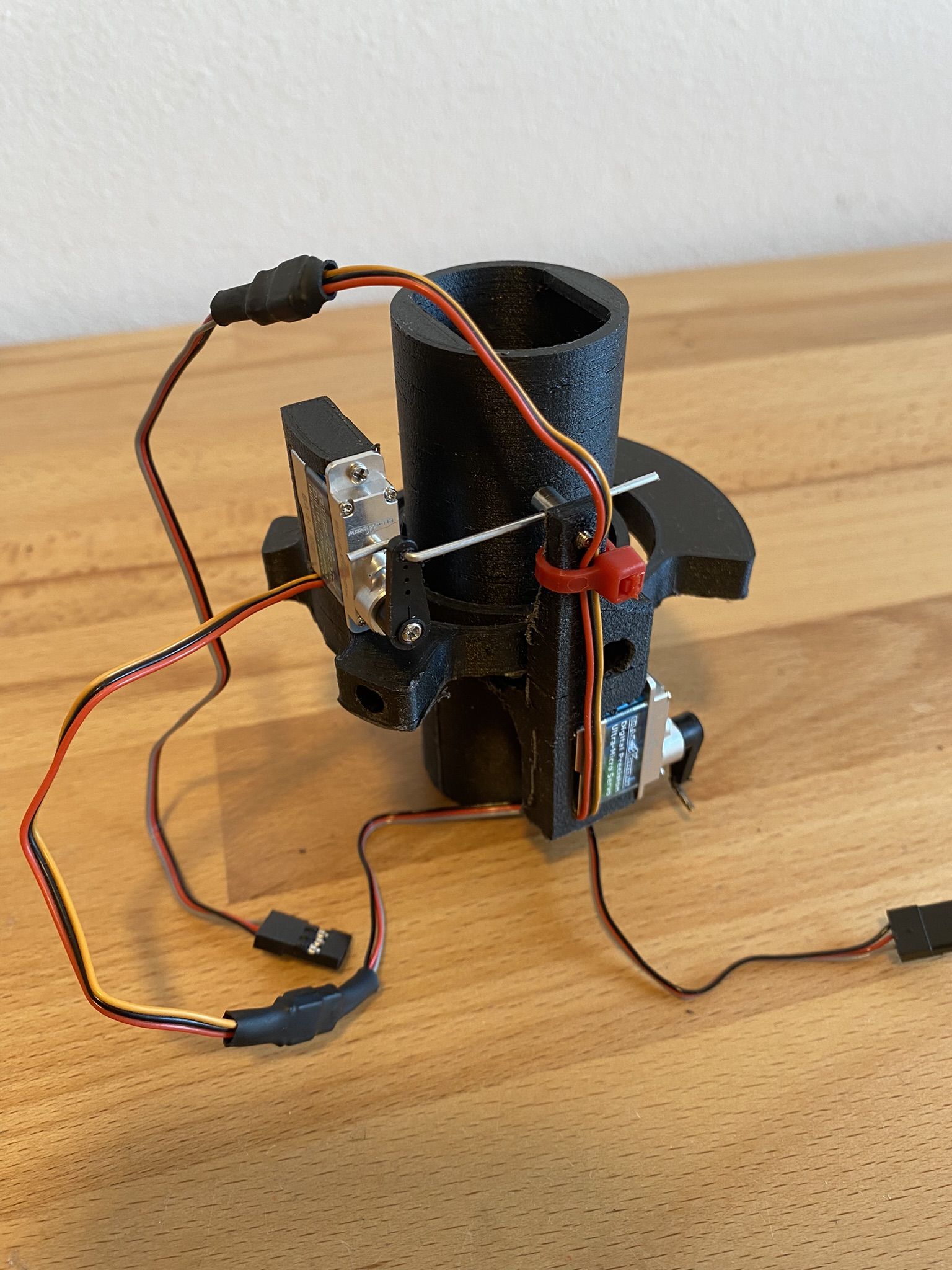 The mk6 gimbal with two servos and their wires on a wooden desk